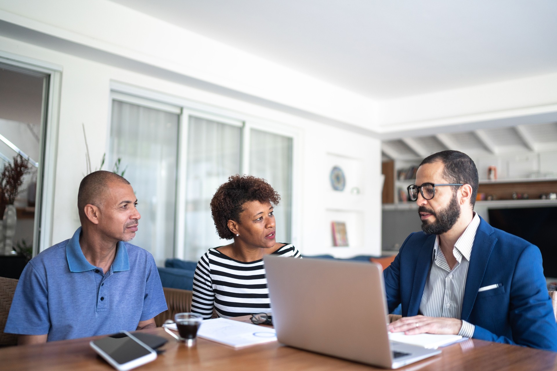 Couple talking to financial advisor at home